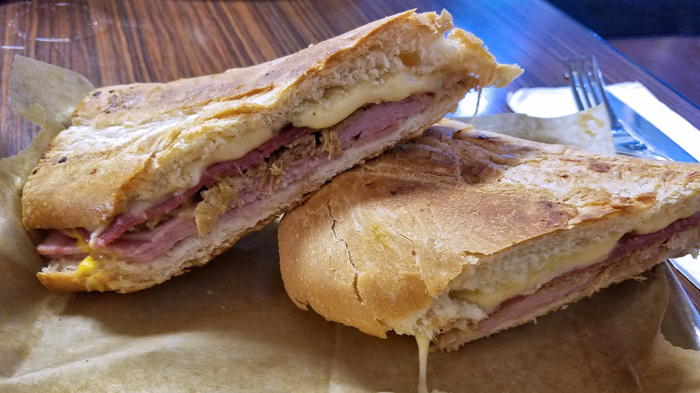 Pressed Cuban sandwich sitting on a table.