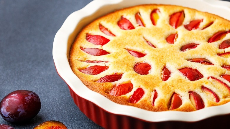 Plum pie in a ceramic pie dish