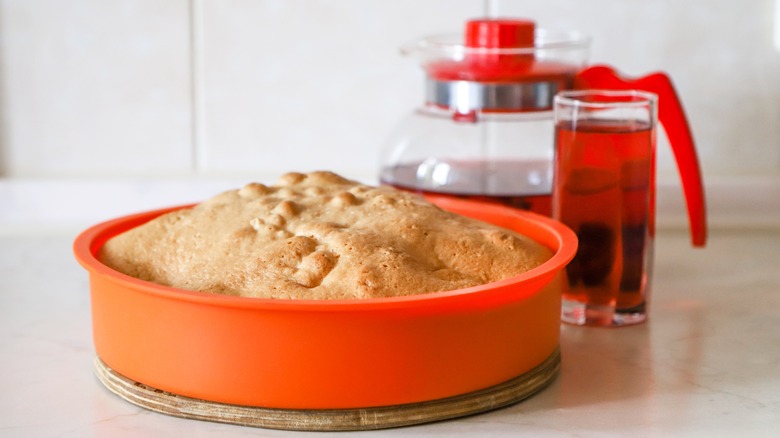 Apple pie in an orange silicone pie pan