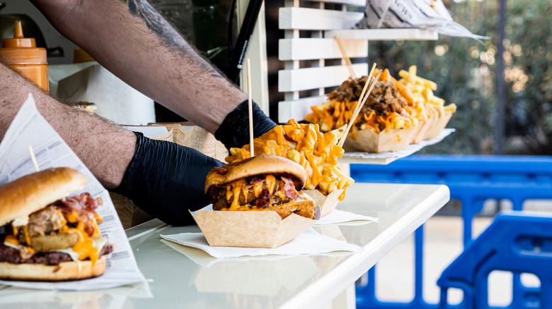 Burgers and French fries on food truck counter