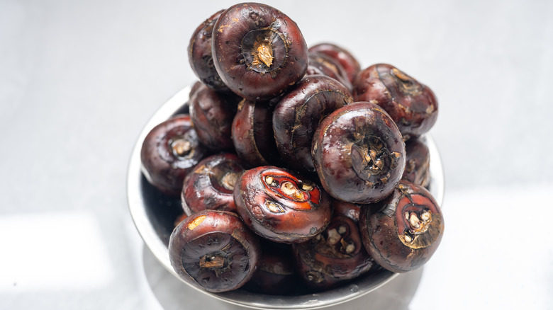 Small bowl piled high with brown water chestnuts