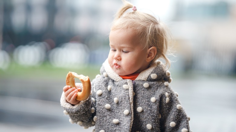 child staring at bagel 