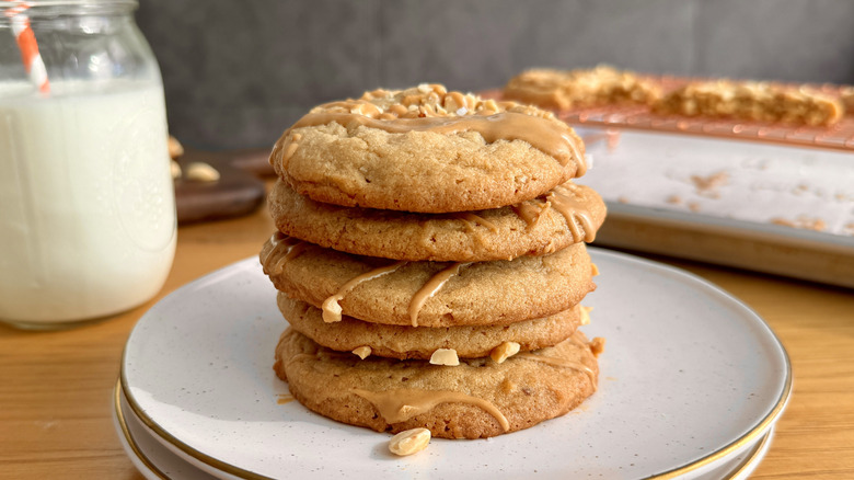 A stack of peanut butter cookies on a speckled plate