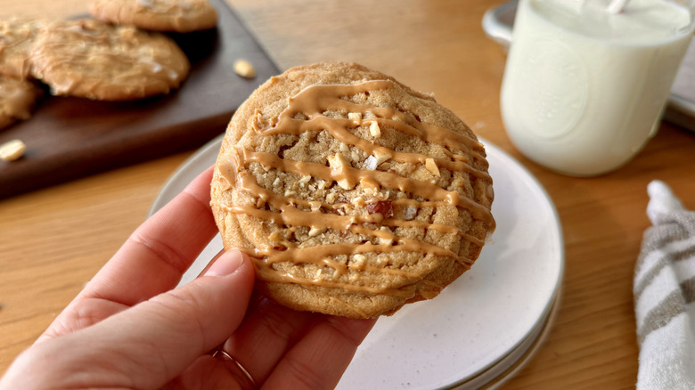 Hand holding a peanut butter cookie