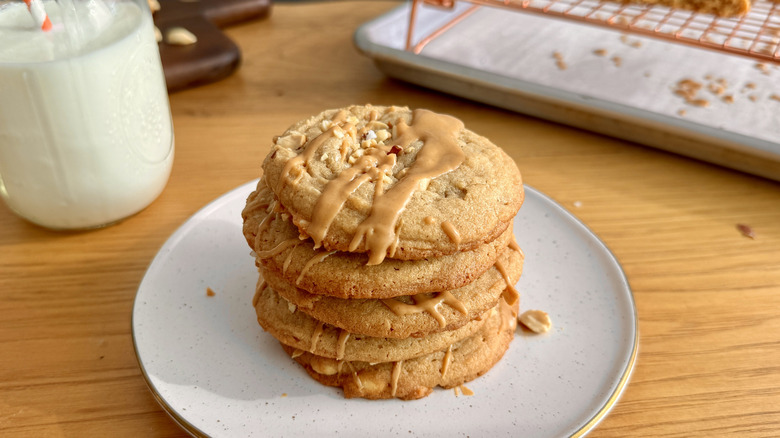 A stack of peanut butter cookies on a speckled plate