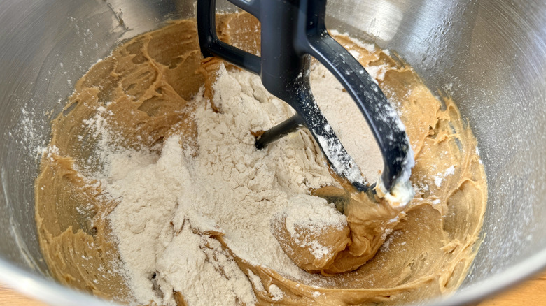 Dry ingredients and cookie dough in a stand mixer