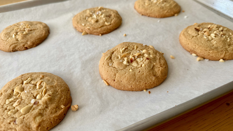 Baked peanut butter cookies on a parchment-lined baking sheet