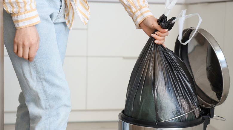 Person removing kitchen trash