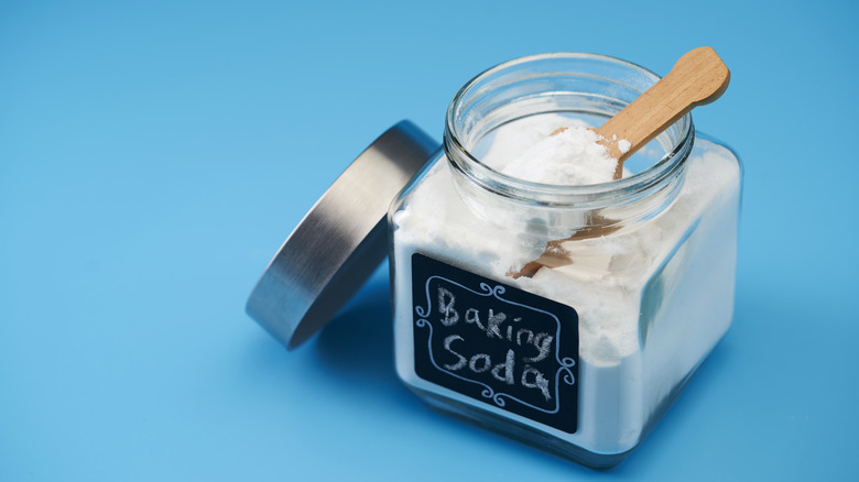 Open glass jar of baking soda