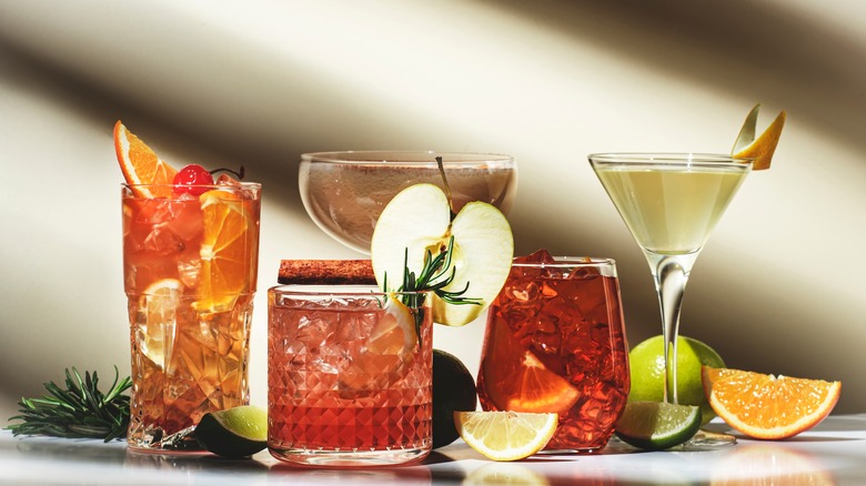 Assorted cocktail drinks garnished with fruit