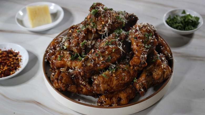 large plate of glazed fried chicken wings