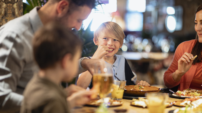 a family eating a meal at a casual sit-down restaurant