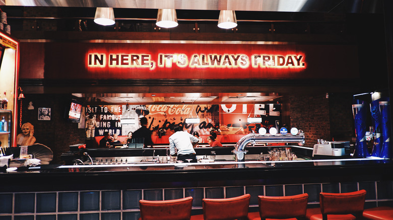 TGI Friday's interior with a sign of the chain's slogan