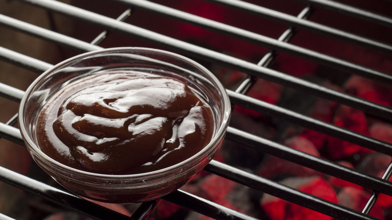 bowl of barbecue sauce on grill