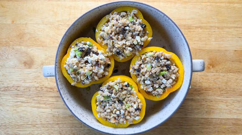 Barley and walnut-stuffed bell peppers in baking dish