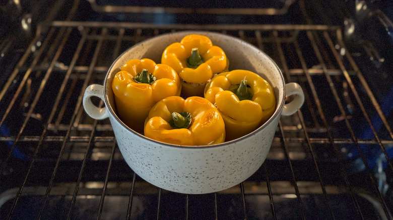 Stuffed bell peppers in casserole dish in oven