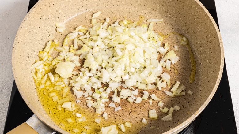 Skillet with chopped onion and olive oil