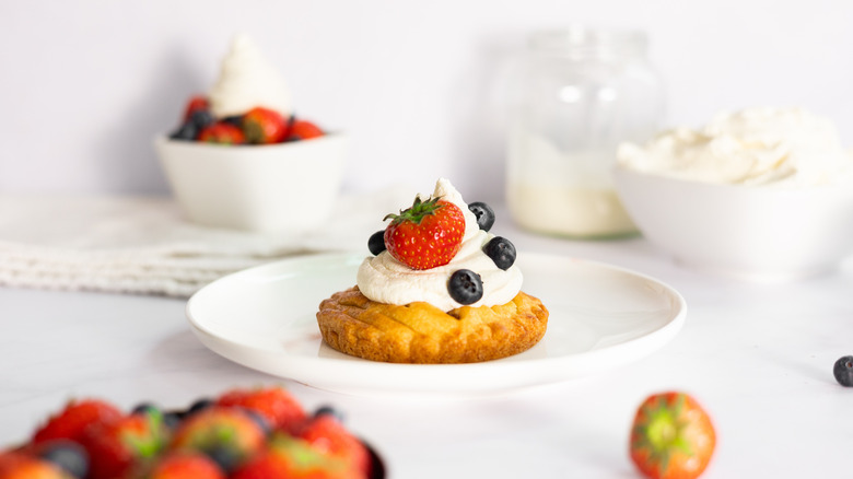 whipped cream and berries on tart