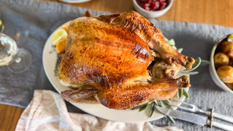 Basic roasted turkey on serving platter on table