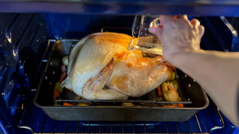 Adding wine to turkey roasting pan