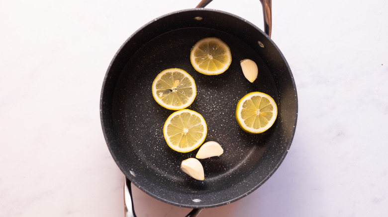 water in pot with lemon and garlic