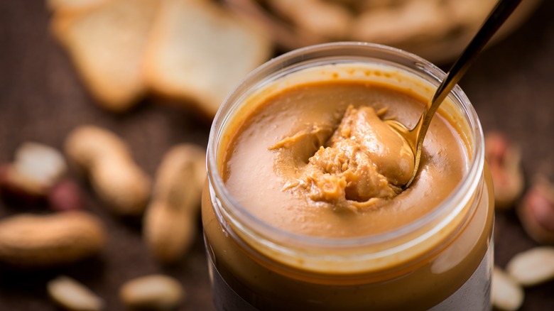 Spoon scooping natural peanut butter