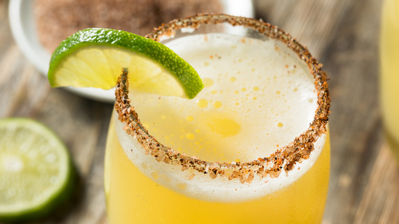 Mexican beer chelada drink in salt-rimmed glass
