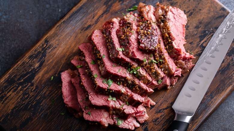 Slices of corned beef on cutting board