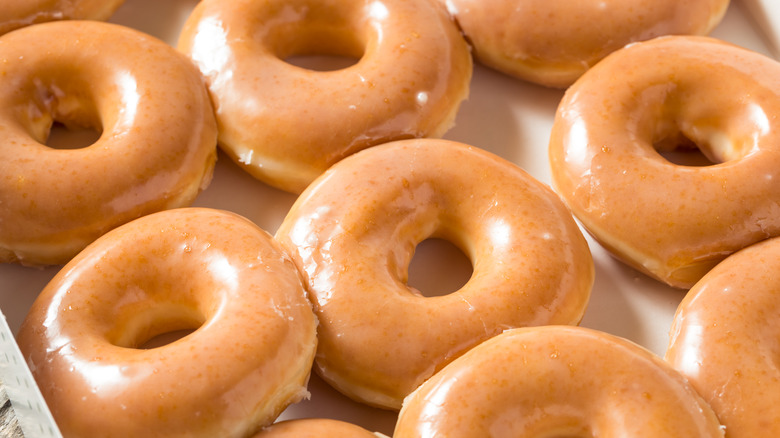 a pan of fresh glazed donuts