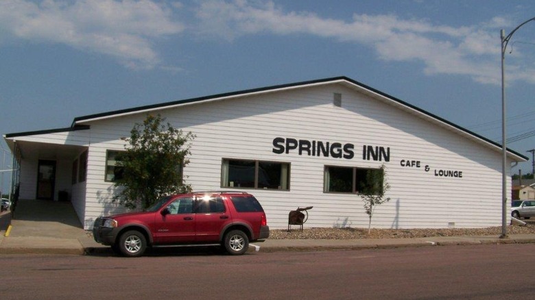 Exterior of Springs Inn Cafe with a red SUV in front