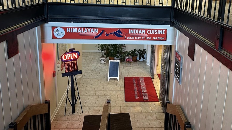 On the steps leading to the entrance of Himalayan Indian Cuisine