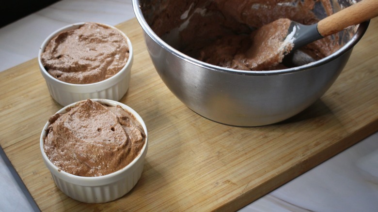 mixing bowl and two ramekins of chocolate mousse