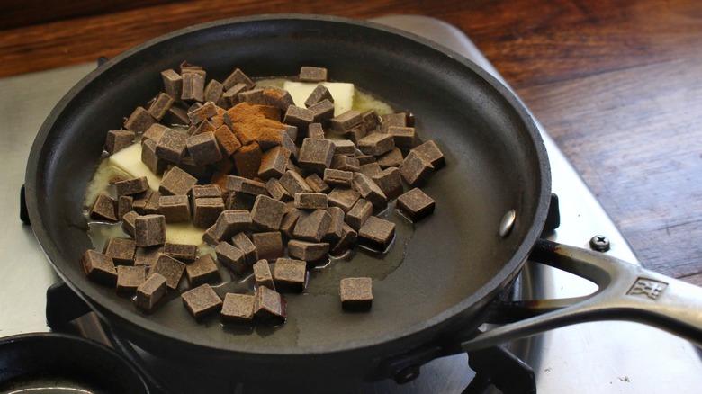 skillet with butter, chocolate, and cinnamon