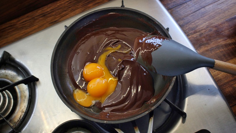 stirring egg yolks into melted chocolate