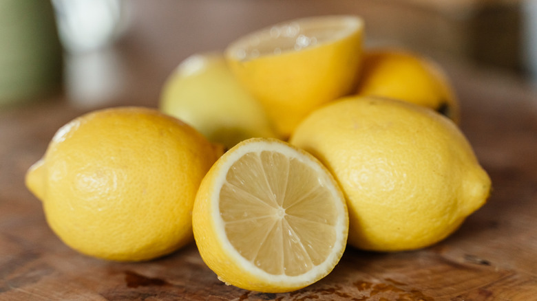 pile of lemons with one cut in half