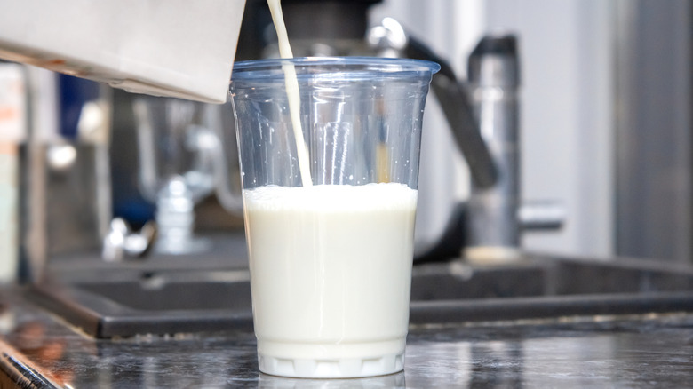 Milk being poured into a cup