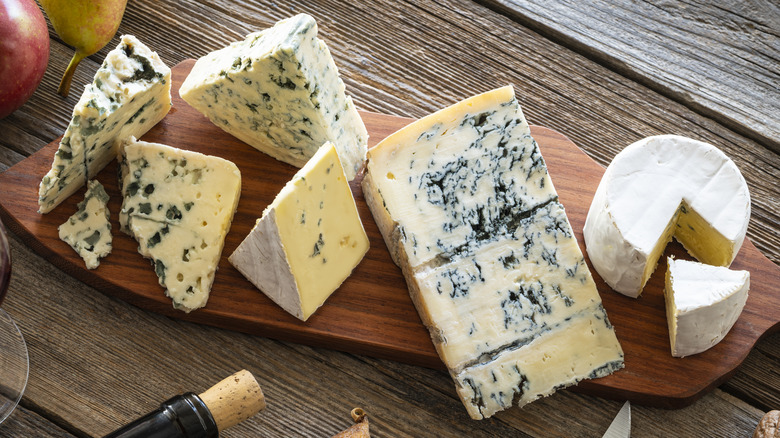 Blue cheeses on wooden board