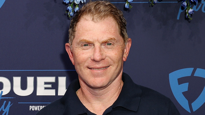 bobby flay smiling in blue shirt