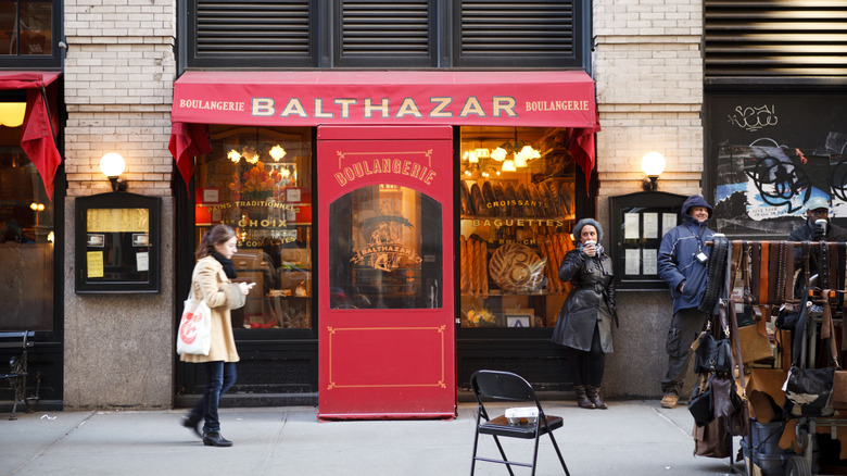NYC's Balthazar restaurant with red awnings outside.