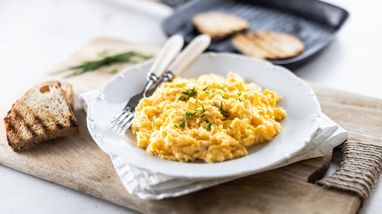 scrambled eggs on plate with silverwear