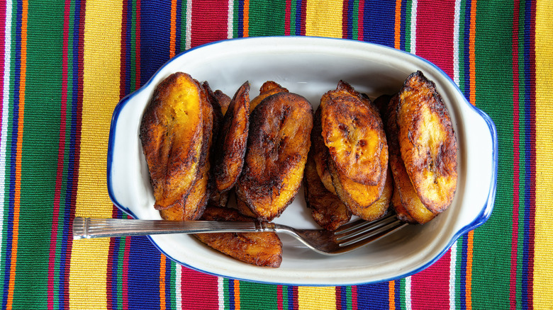 Fried plantains in baking dish on colorful mat