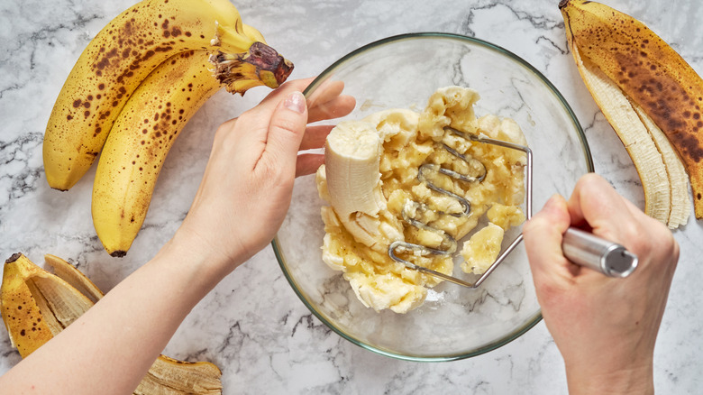 mashing bananas in bowl