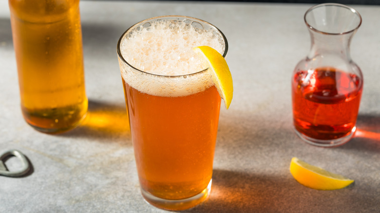 Negroni beer cocktail next to its ingredients