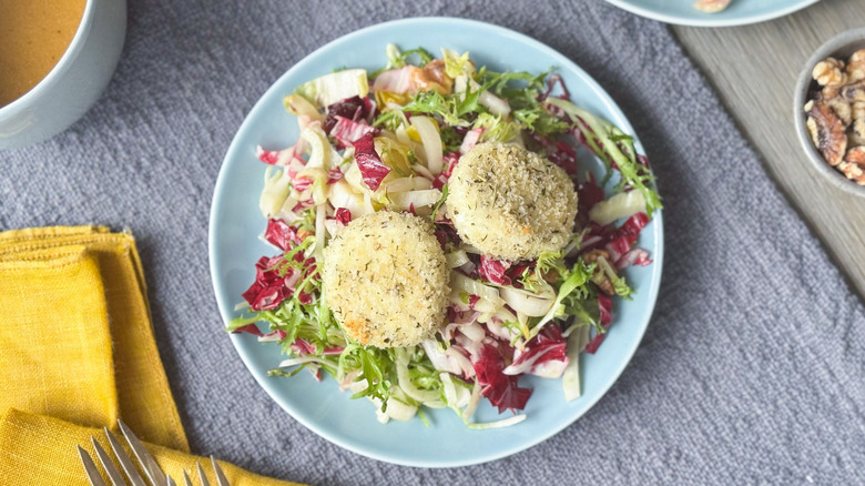 Breaded and baked goat cheese salad on plate