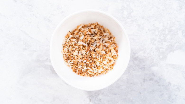 Shredded toasted coconut in white bowl