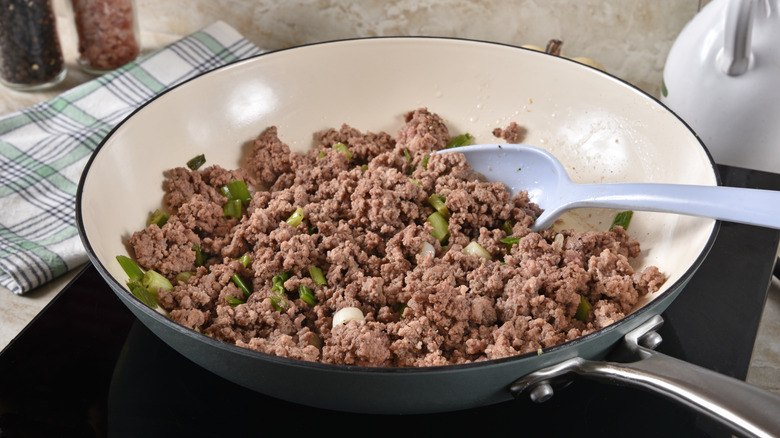 crumbled browned ground beef and onions in a pan