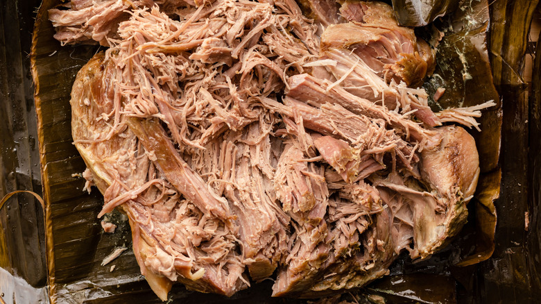 close-up of kalua pork shredded on cutting board