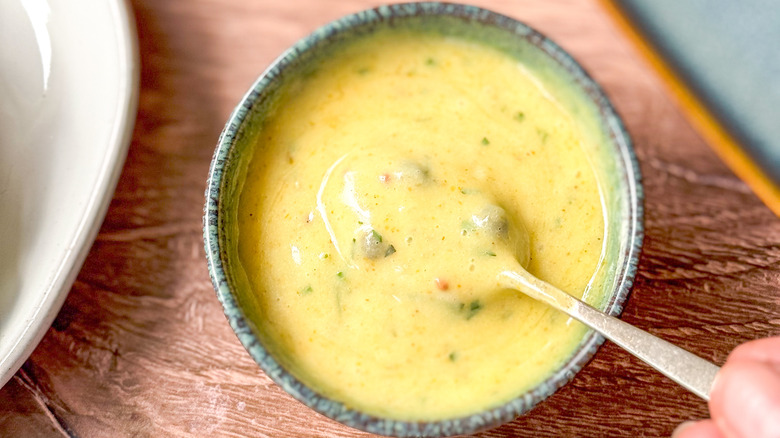 Curry remoulade sauce in bowl with spoon