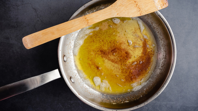 browning butter in pan with a spatula