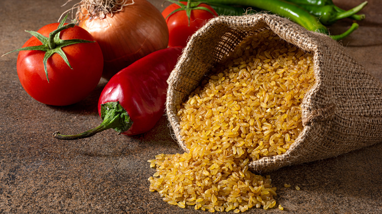 dry bulgur with veggies in the background